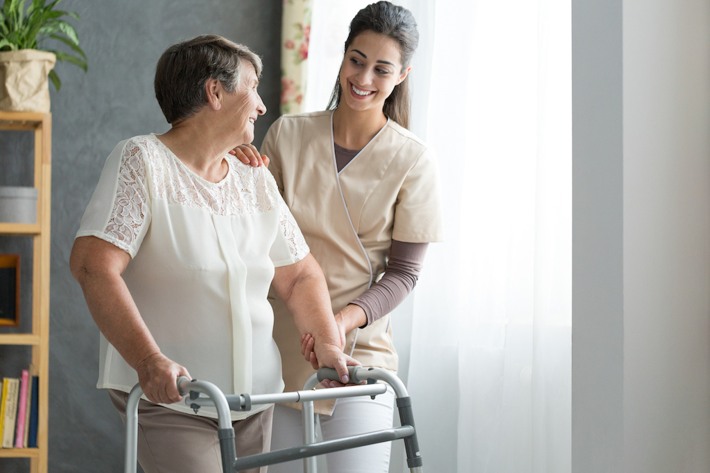 old woman using a walker as she recovers from hip surgery