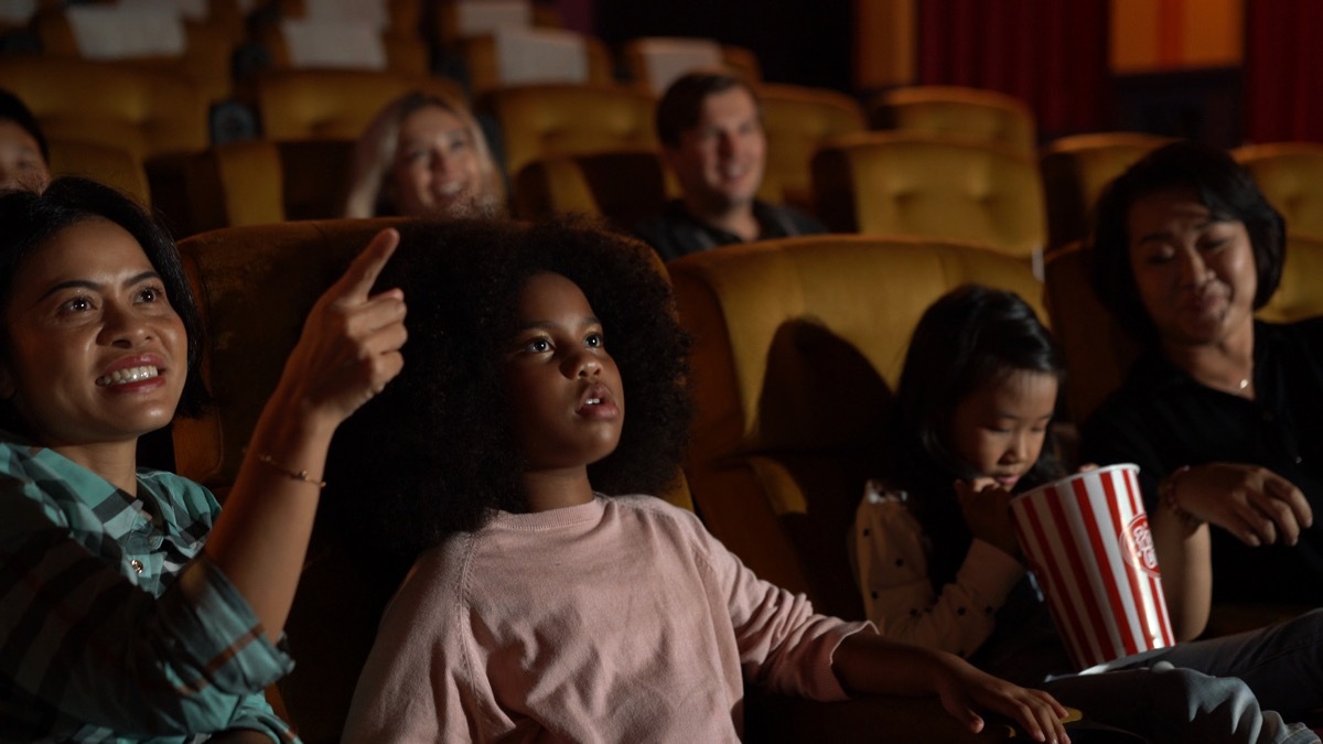 Families watching a movie at the theatre