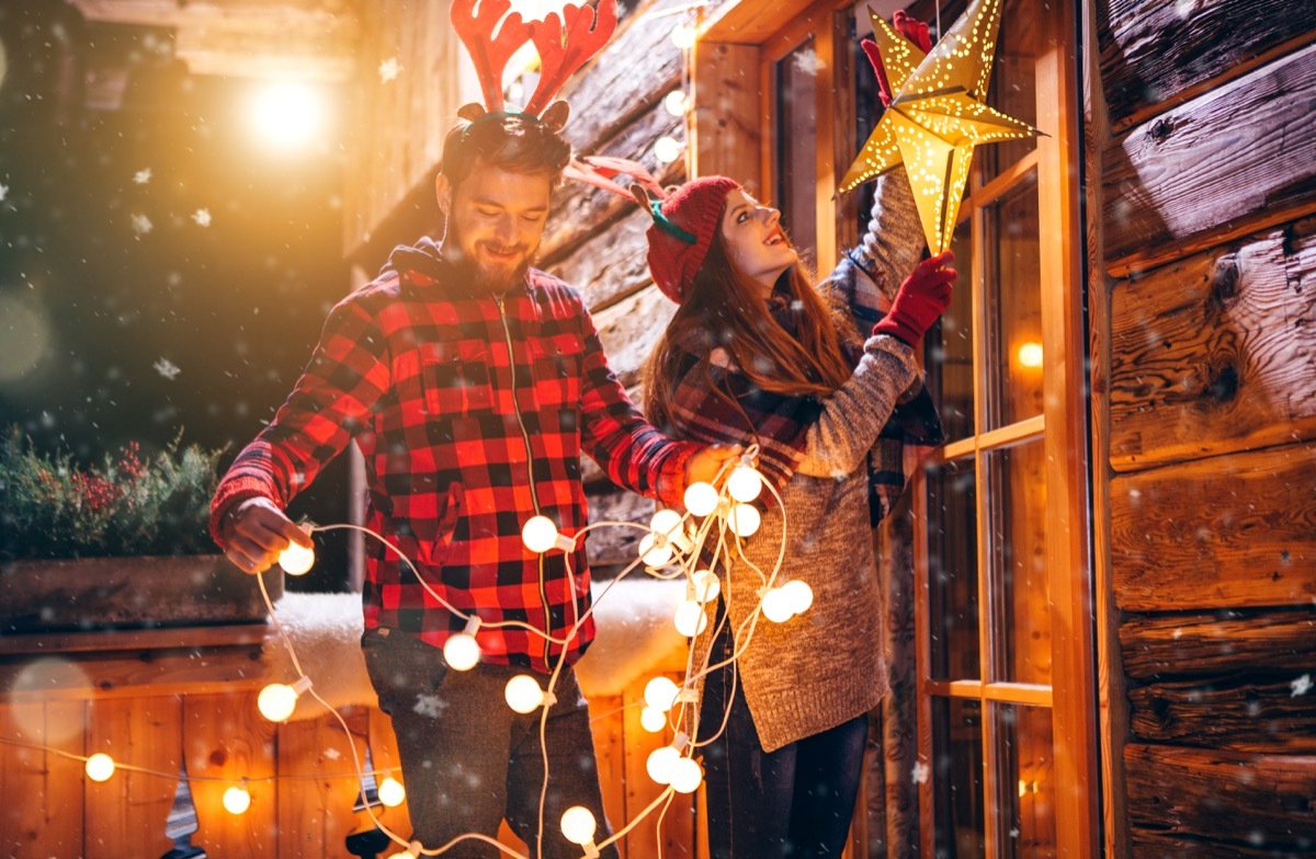 family decorating outside their home