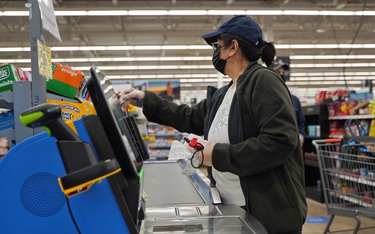 woman using walmart sefl checkout