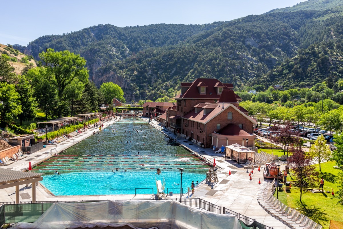 High angle view of famous Colorado hot springs pool in downtown with water and people swimming