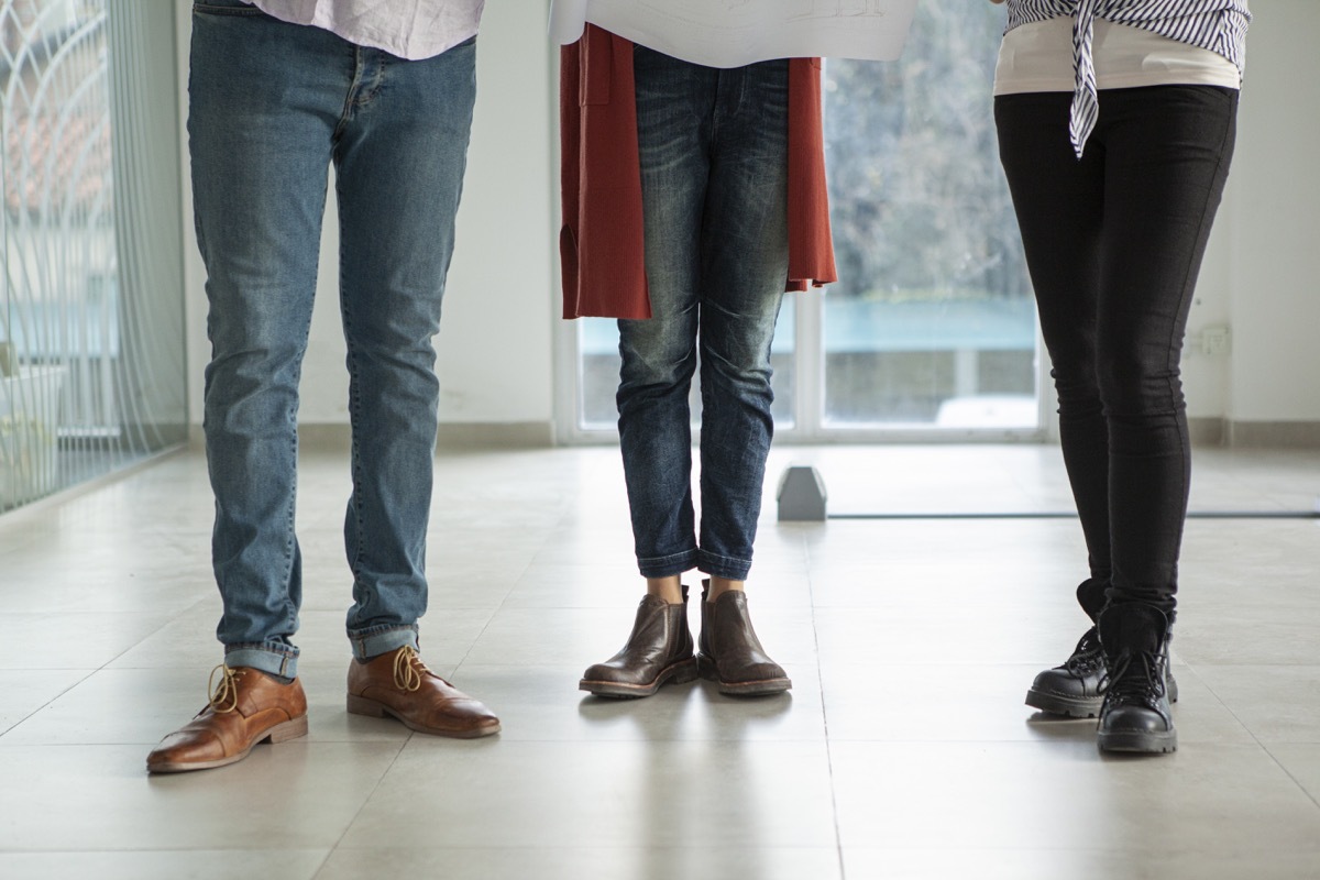 Mid adult people wearing casual clothes while standing inside building during daytime.