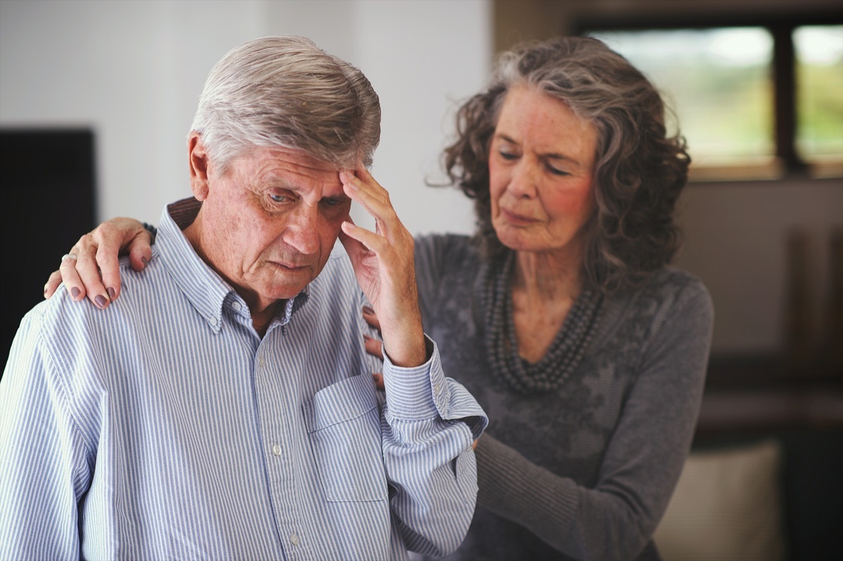 Woman helping man with memory problem at home