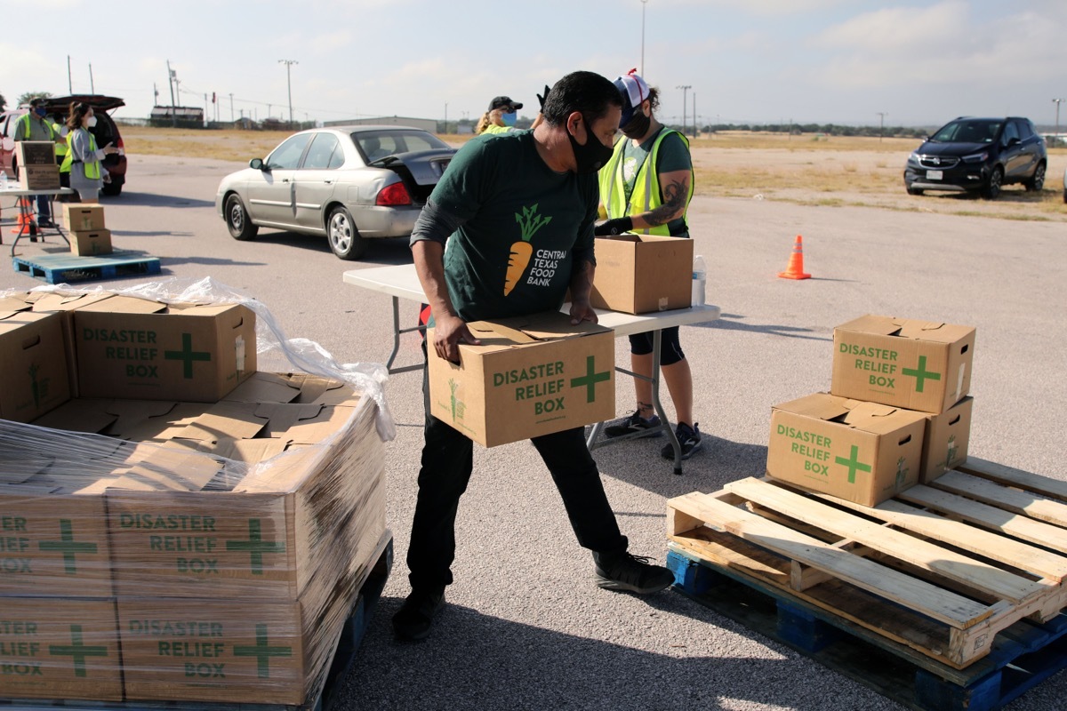 Austin, TX / USA - Nov. 19, 2020: One week before Thanksgiving, an employee of the Central Texas Food Bank transfers Disaster Relief boxes for distribution to people in need.