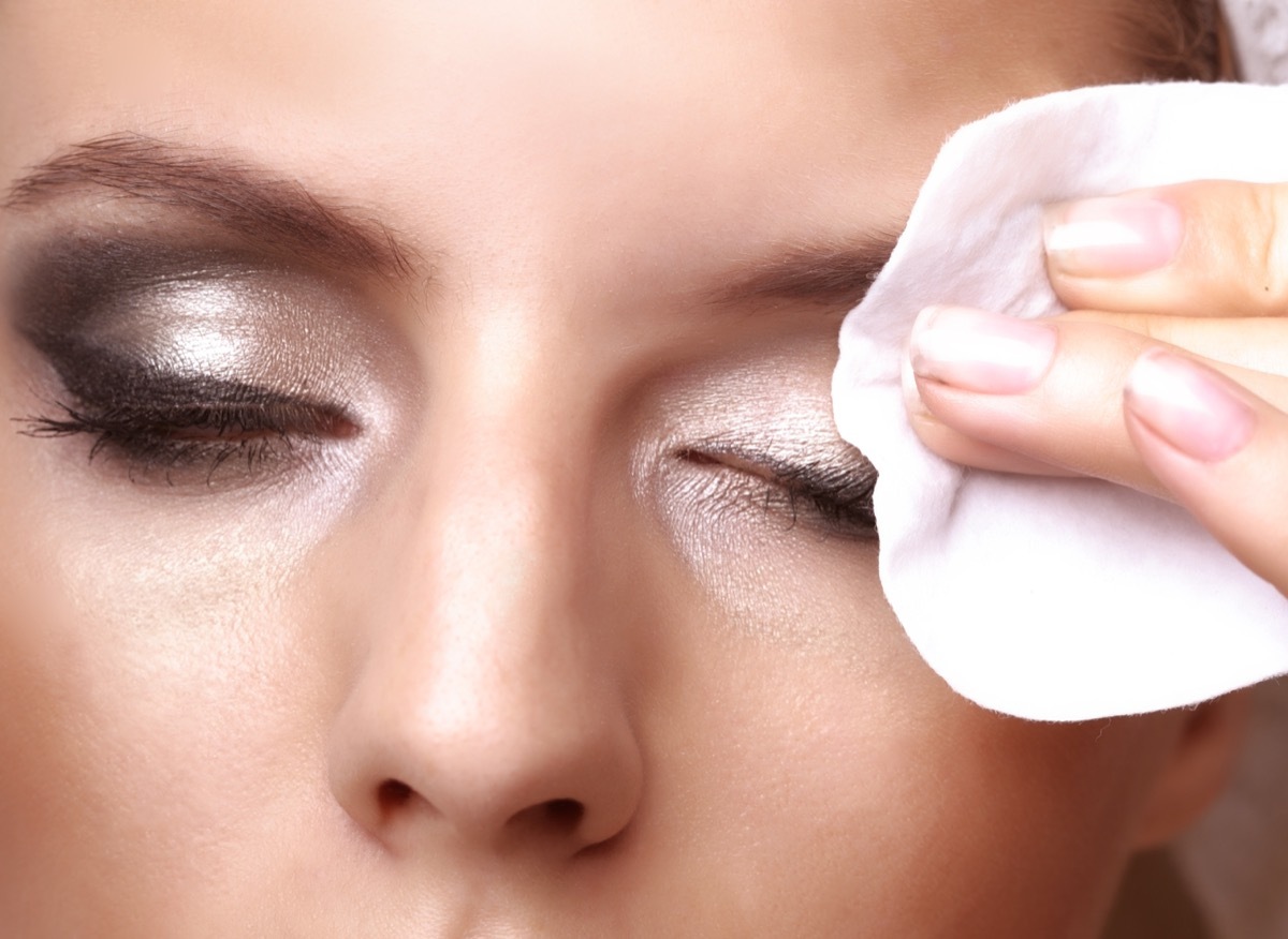 Woman using makeup removing wipe