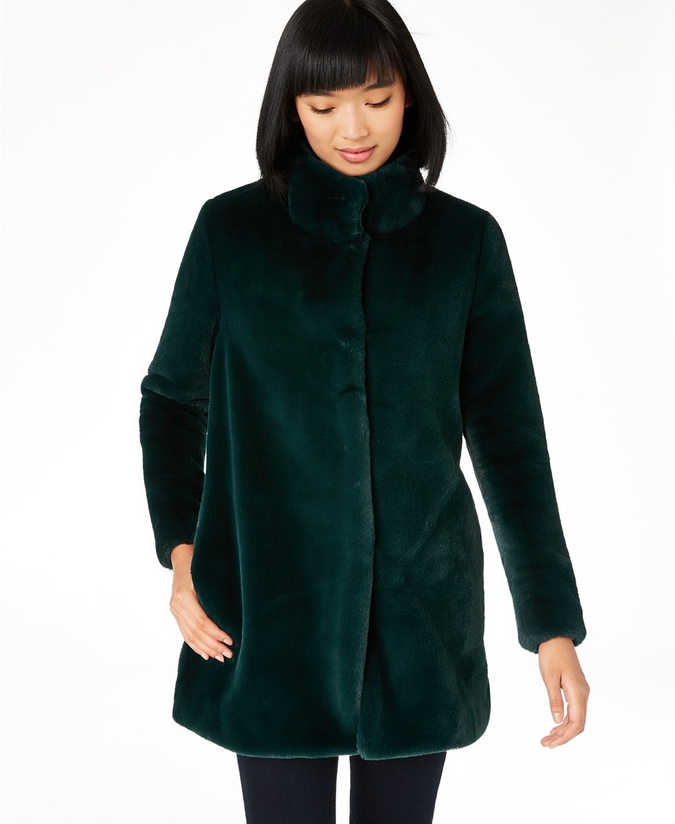 woman with black hair and bangs in green faux fur coat, women's coats for winter