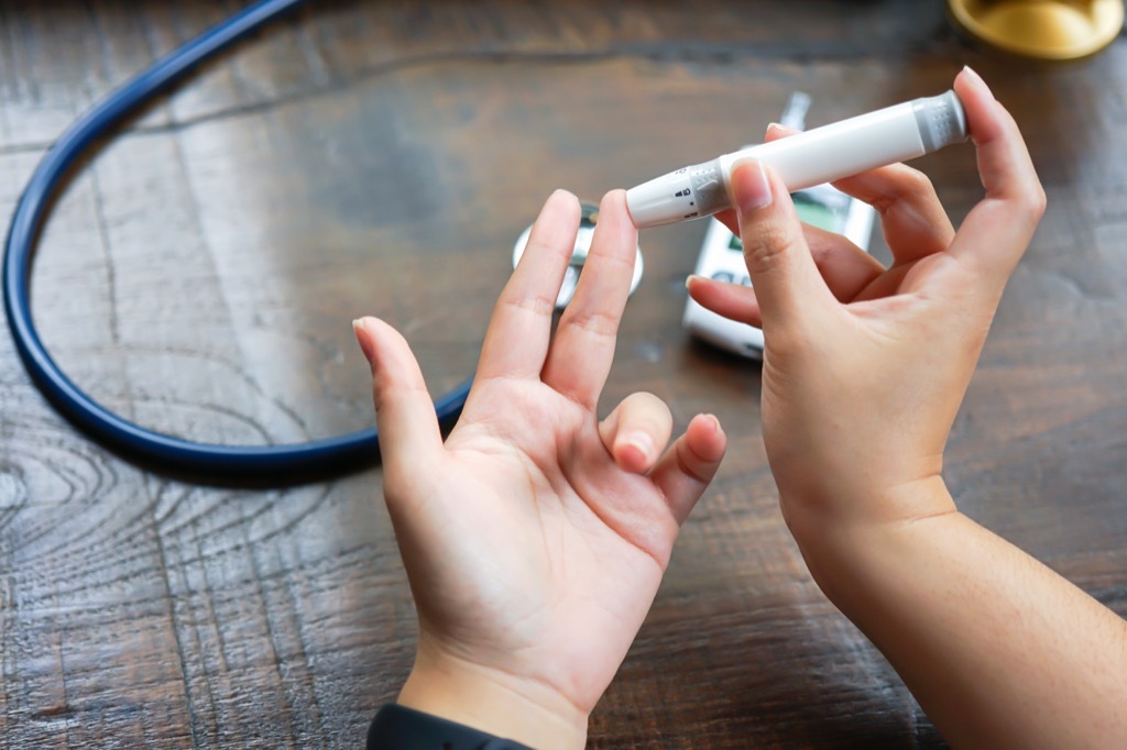 woman checking her blood sugar levels {Thyroid Problems}