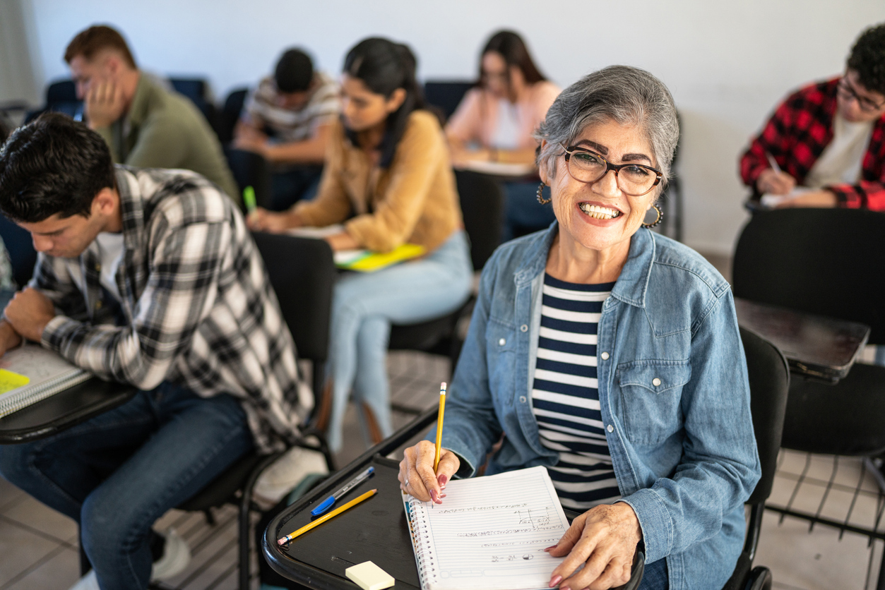 A senior woman sitting in a college lecture