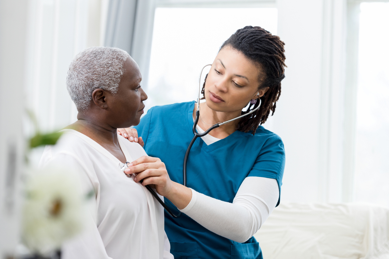 Medical professional listening to a patient's heart