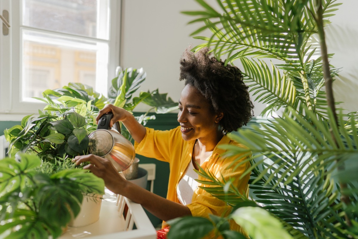 young black woman with houseplants