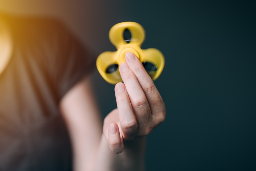 woman holding a fidget spinner