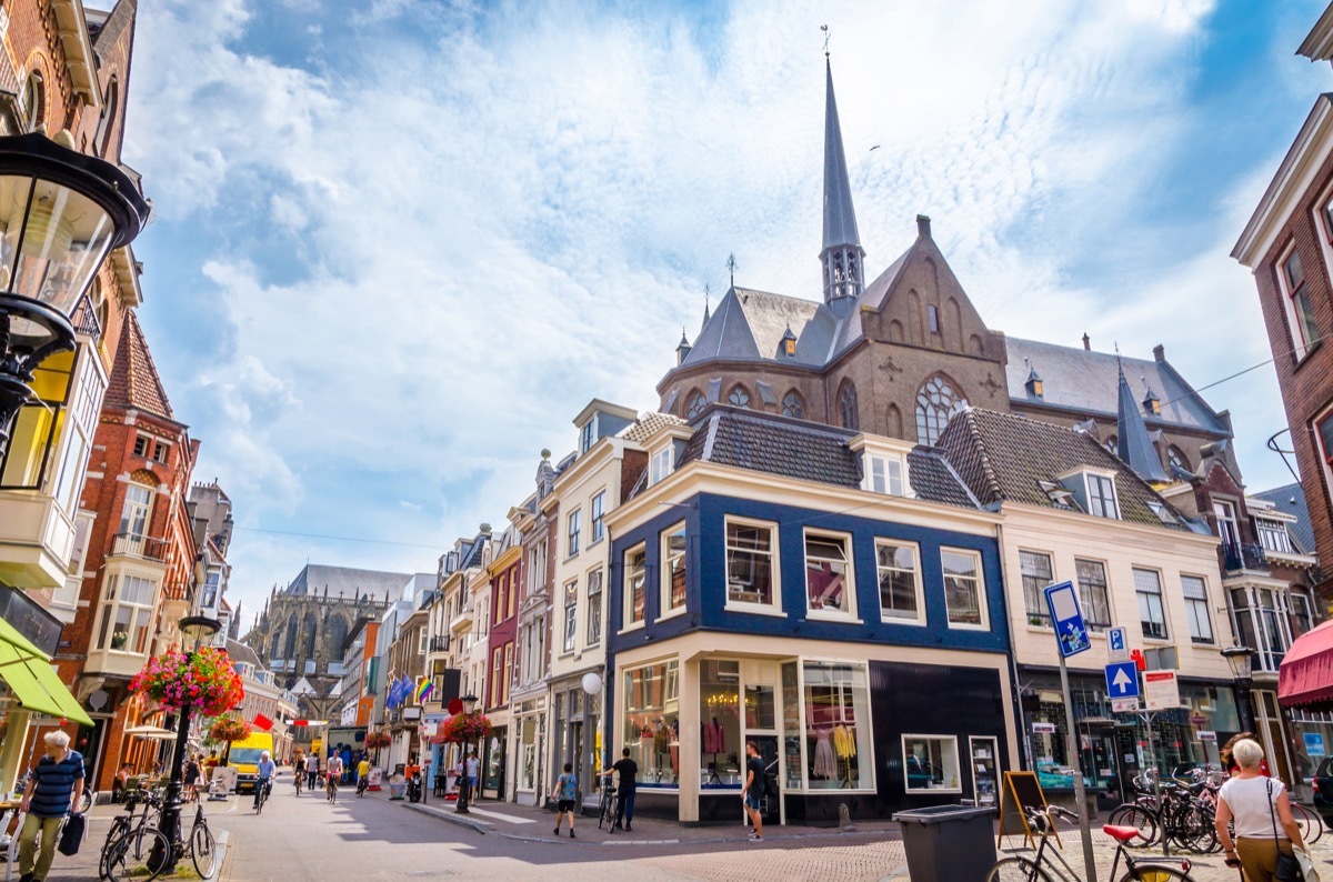 sunny day on a street in utrecht netherlands with a cathedral in the background