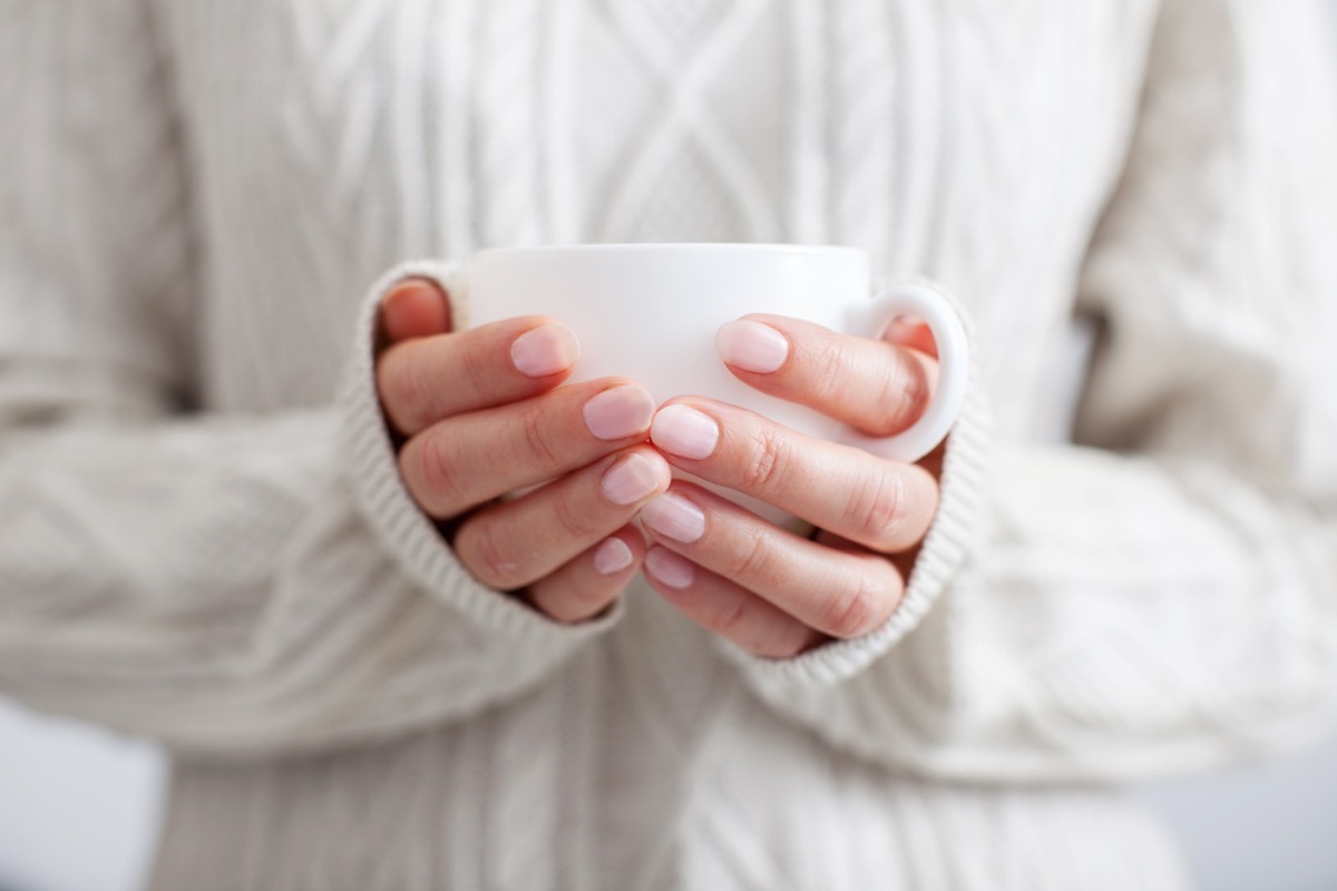 Person holding a mug