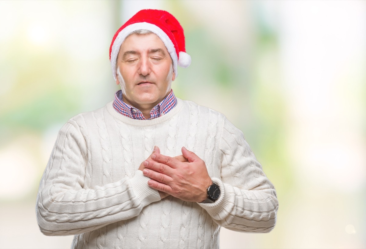 Older man holding his heart in pain on Christmas