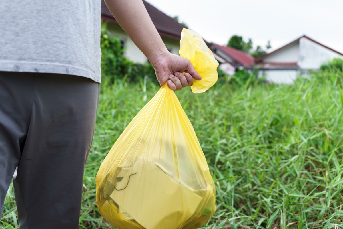 Man Volunteer charity holding garbage yellow bag and plastic bottle garbage for recycling cleaning.