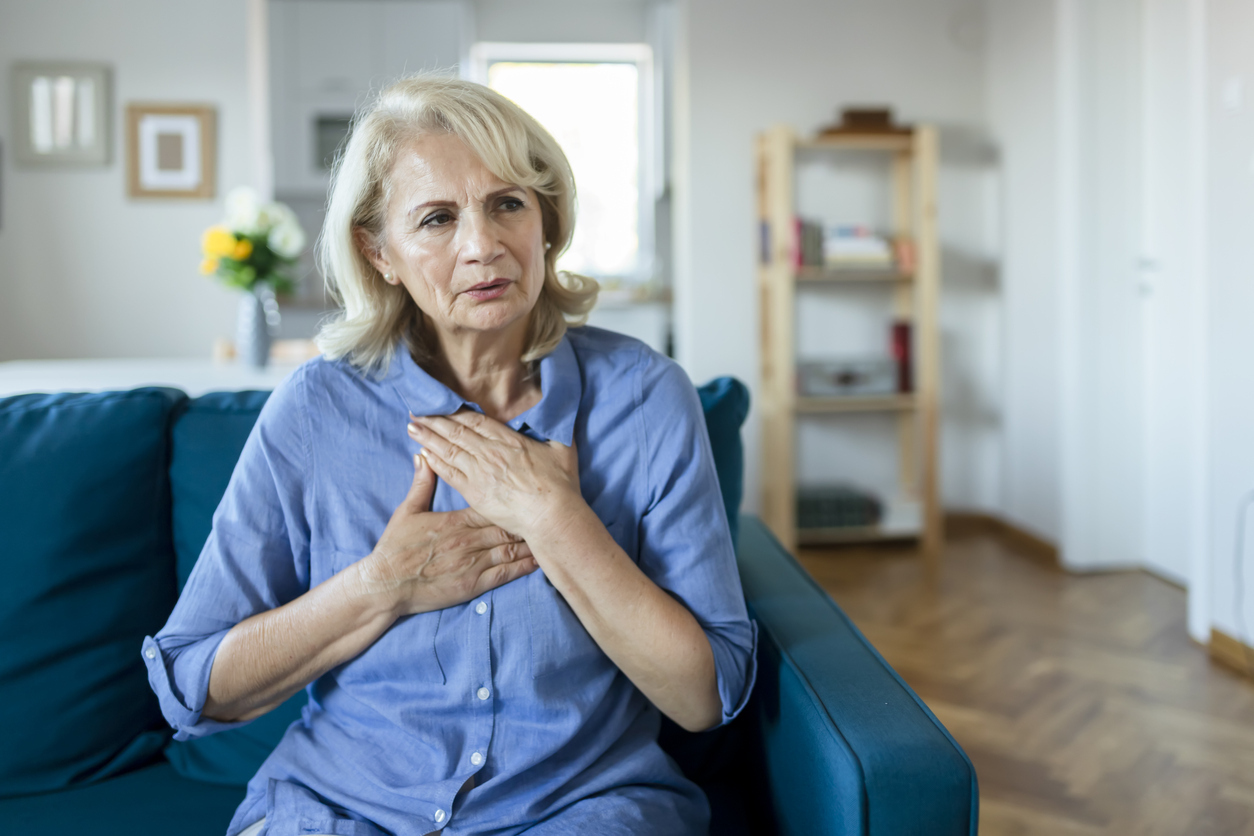 Senior woman with her hands on her chest