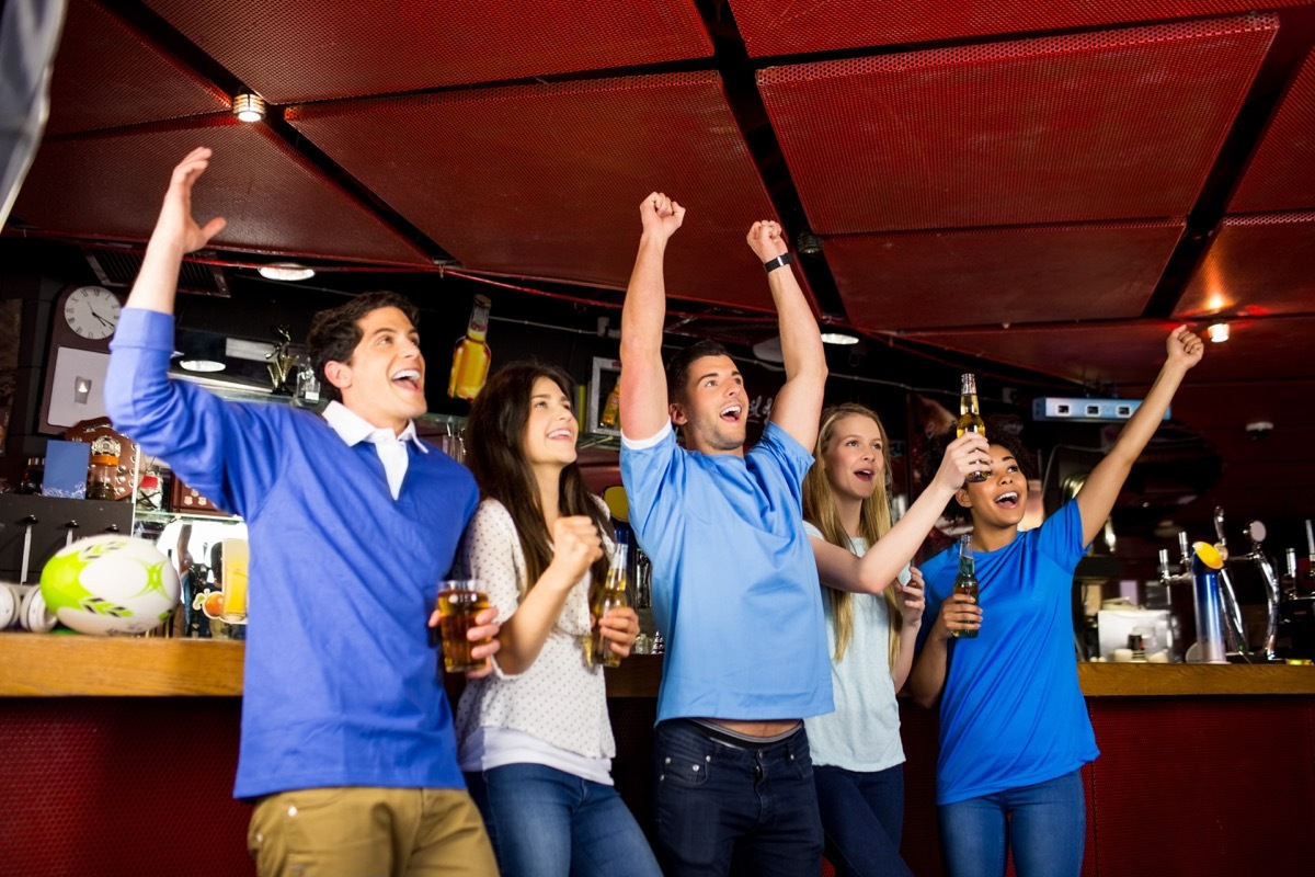 Friends cheering and hanging out at the bar