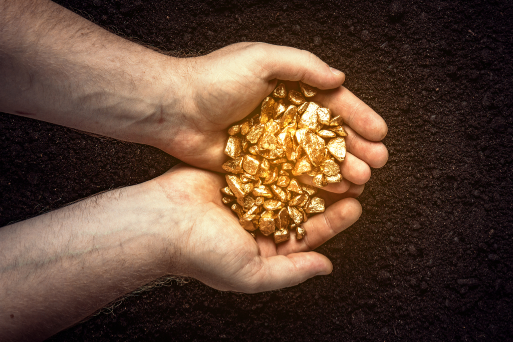 man holding gold nuggets