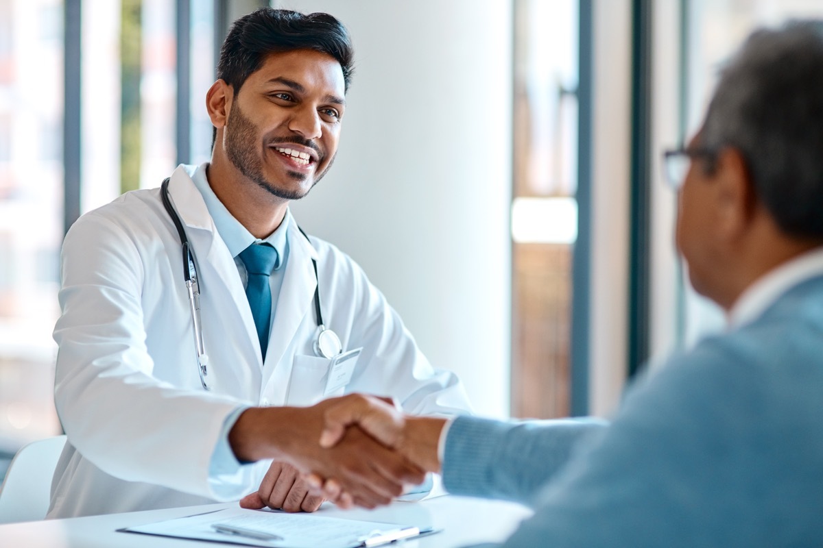 young doctor shaking the hand of his patient