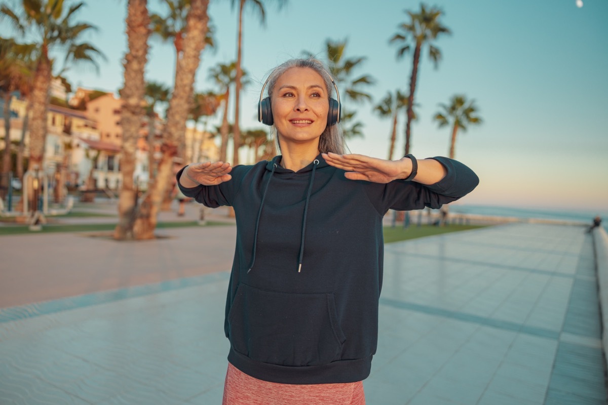 Older Woman Outside with Headphones