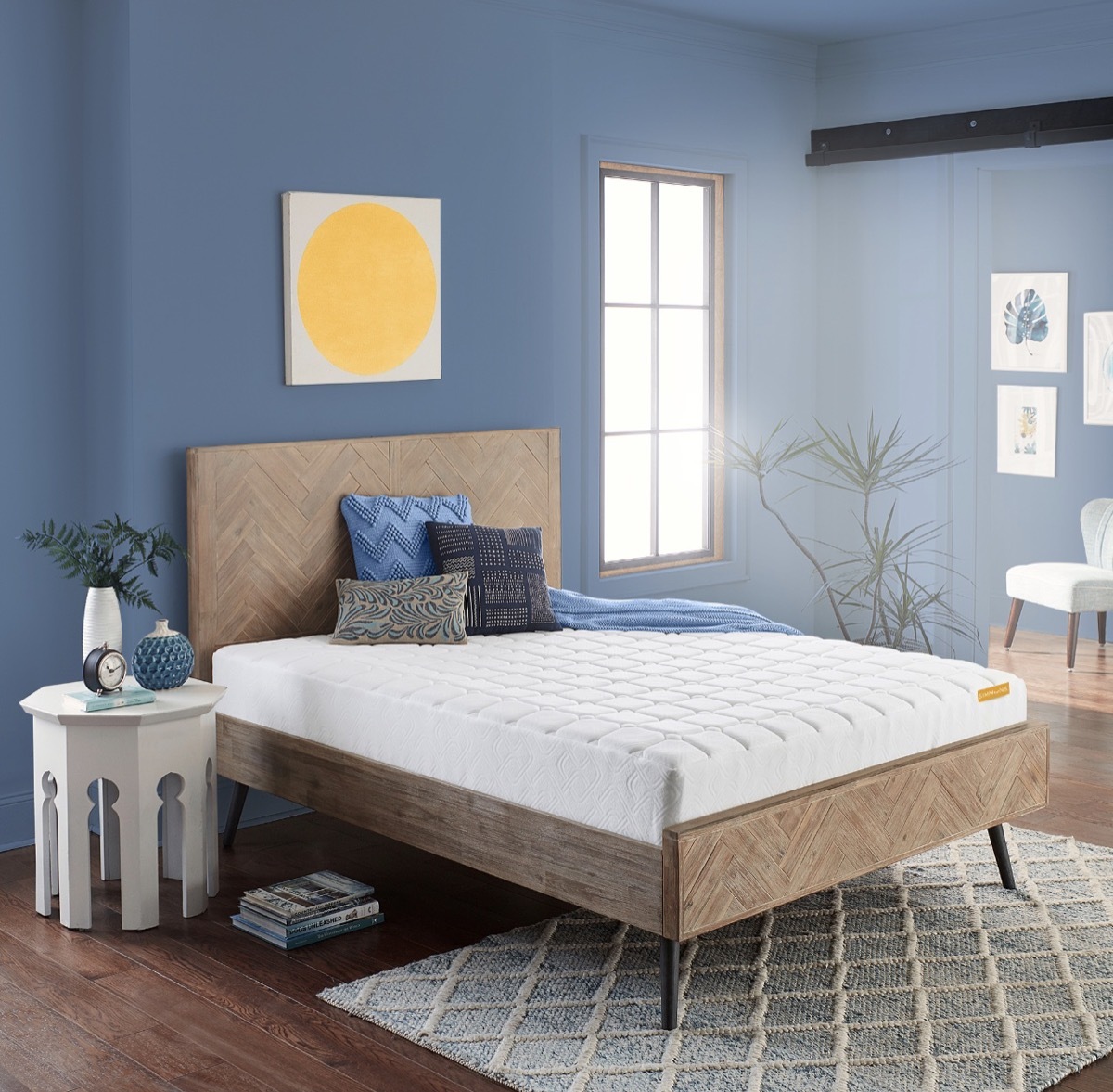 blue bedroom with undressed mattress