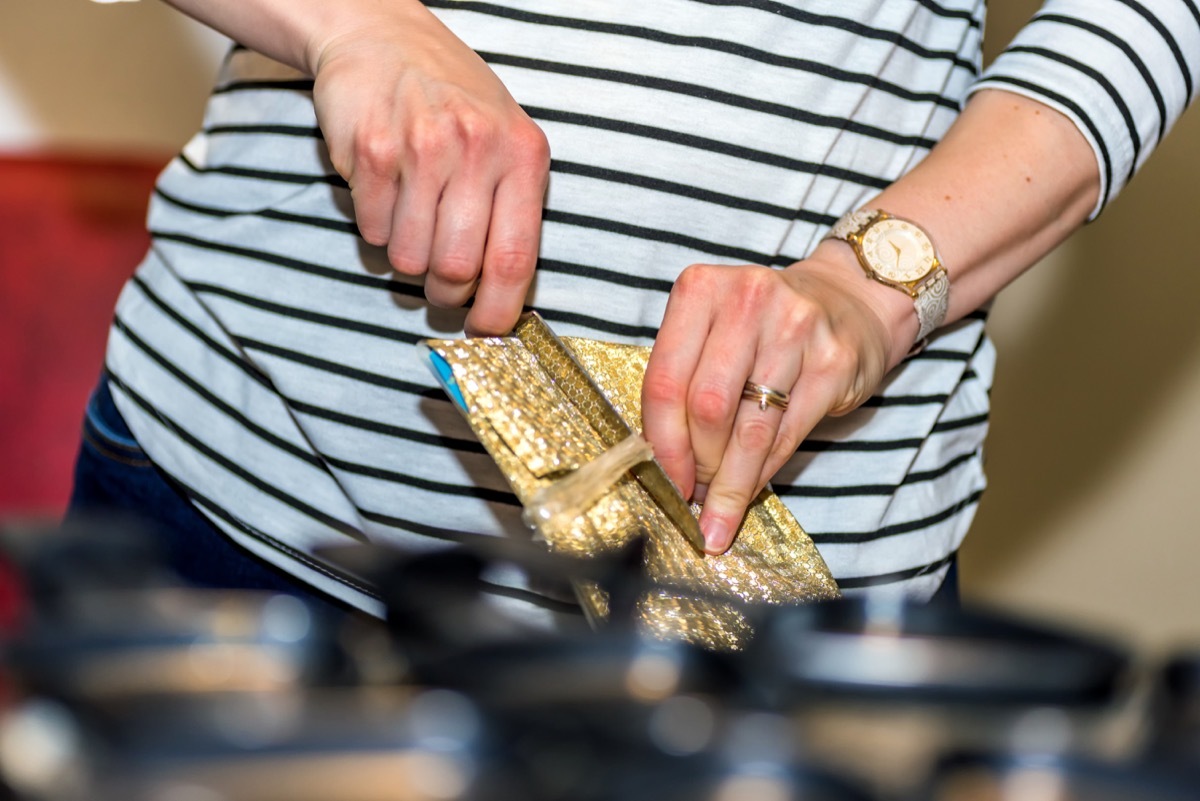 Woman dangerously opening a gift with a knife