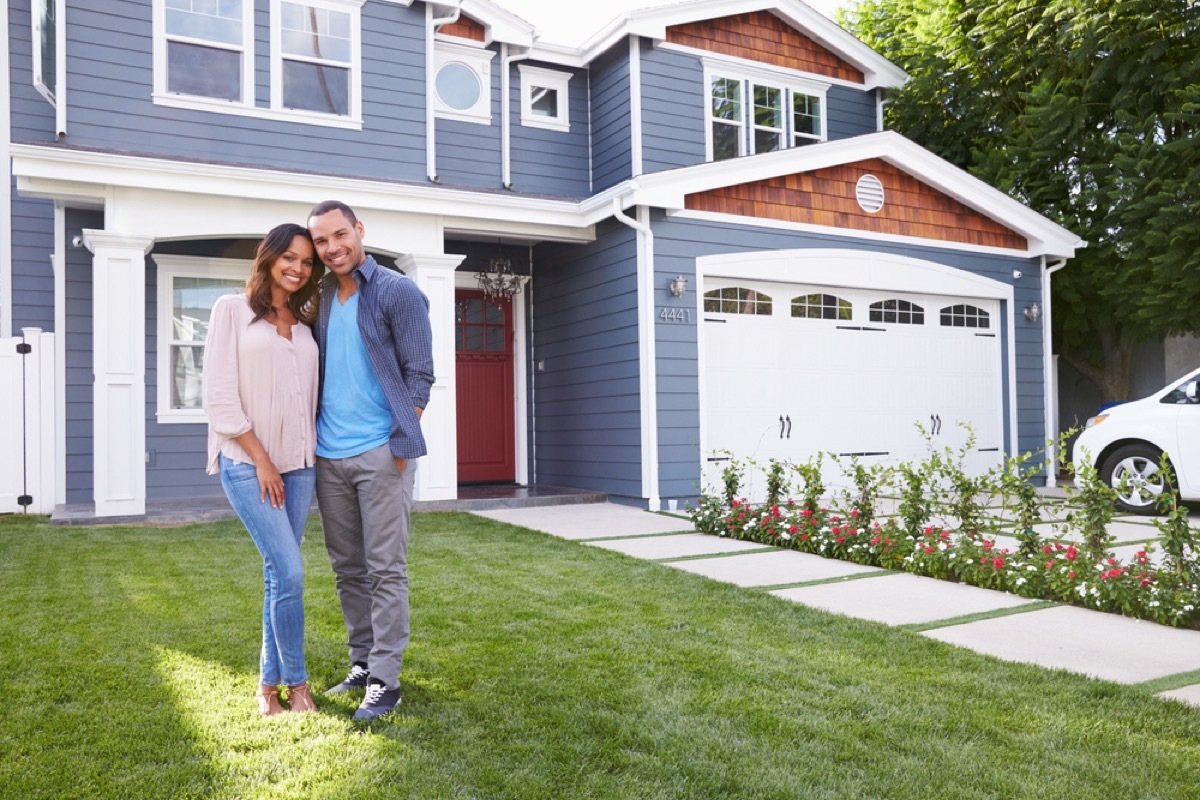 black couple standing in front of suburban house, fire prevention tips