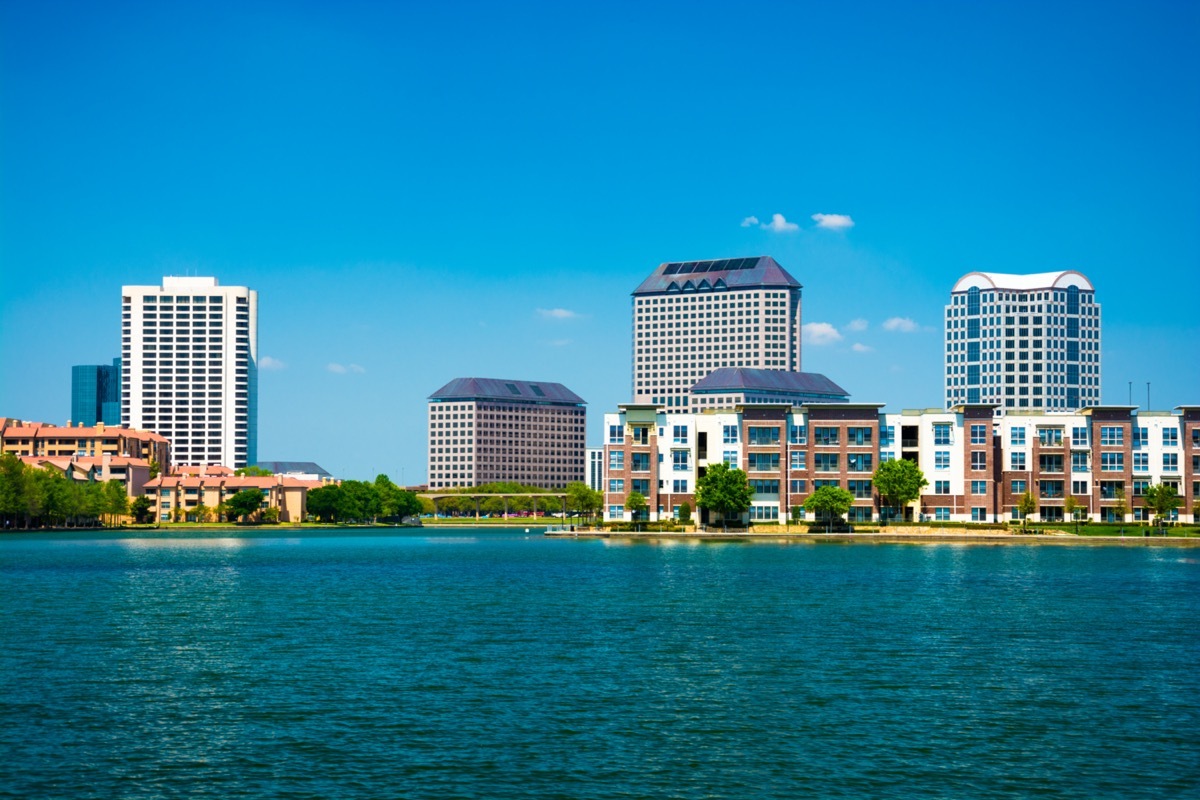 city skyline of Irving, Texas with Lake Carolyn in the foreground