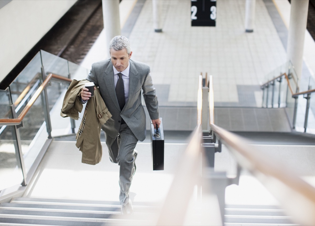 white businessman walking up the stairs