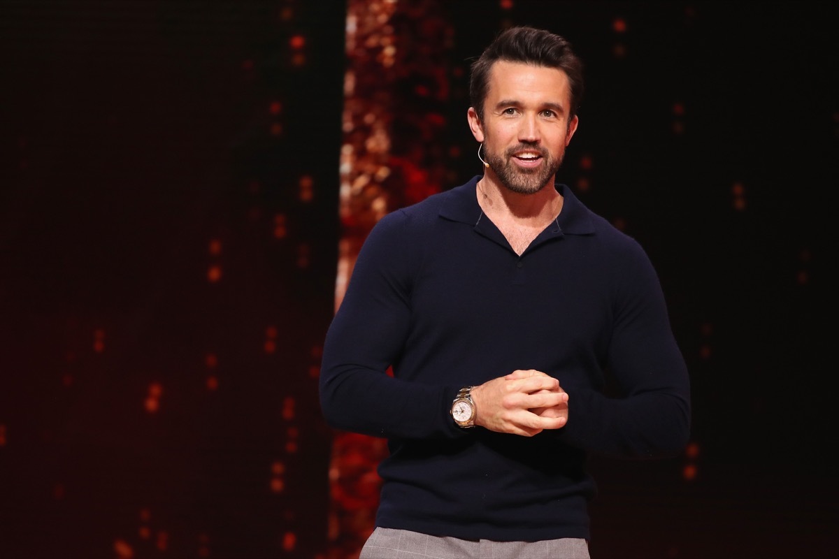 rob mcelhenney with microphone on stage