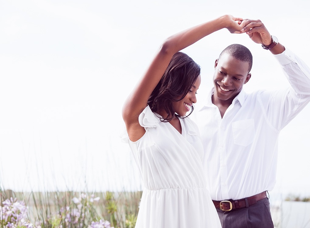 black man and woman dancing outside