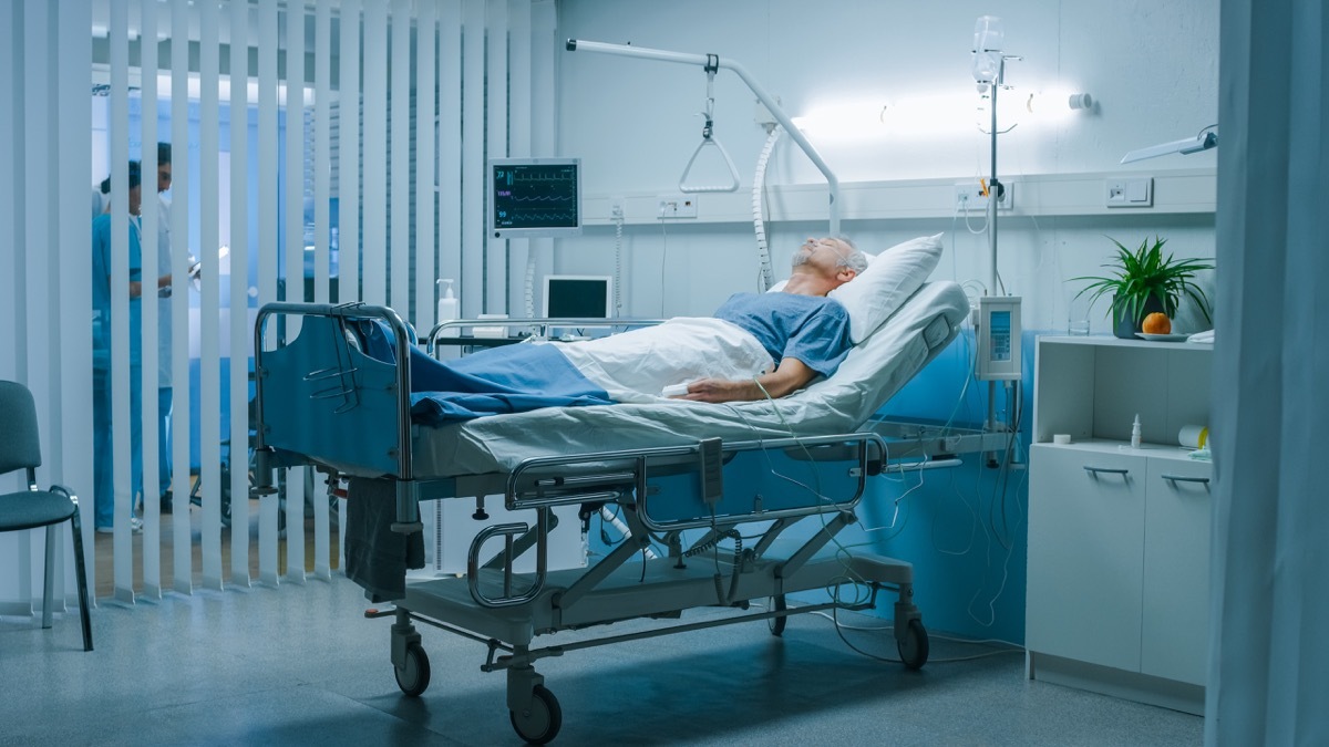 Man laying in hospital bed with coronavirus