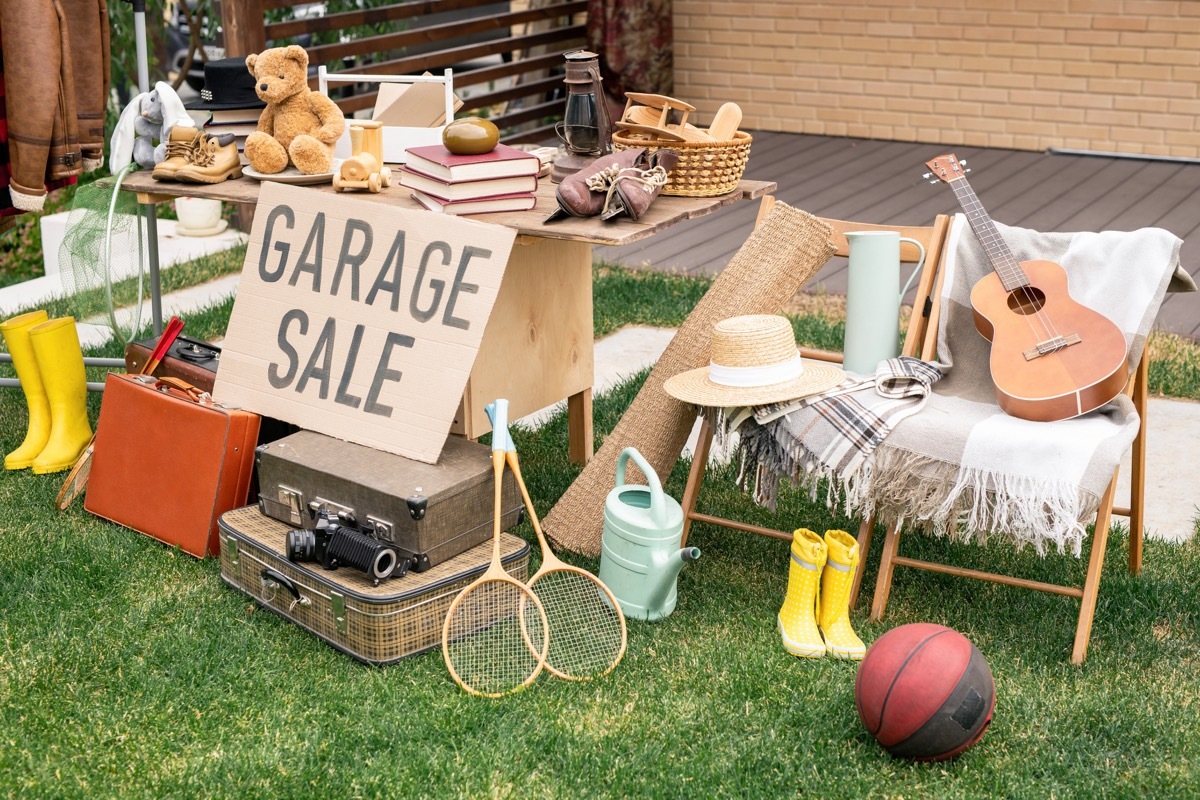 Various things placed on table and chairs in backyard, garage sale concept