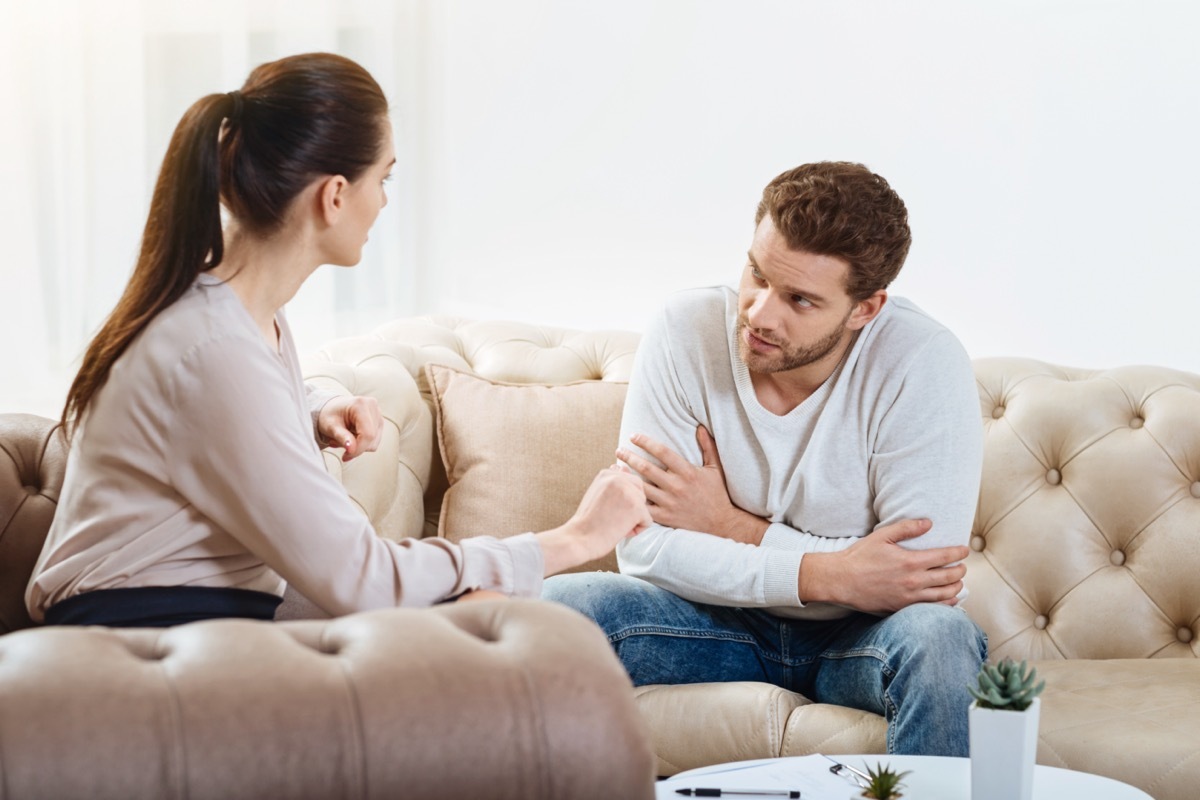 man looking at woman and woman towards to the man on a couch