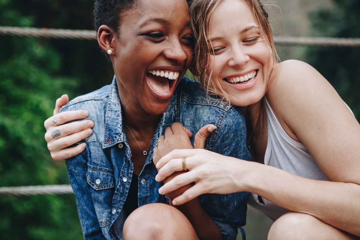 happy couple hugging on park bench