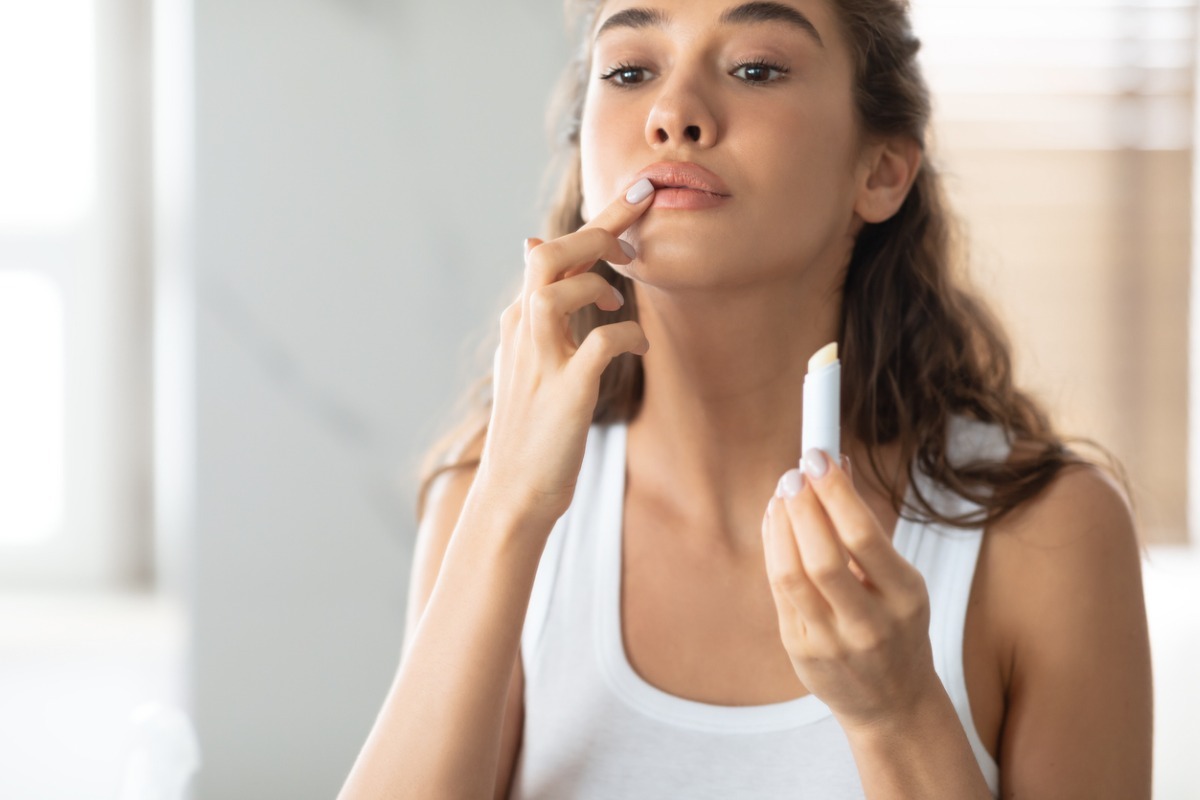 woman applying lip gloss