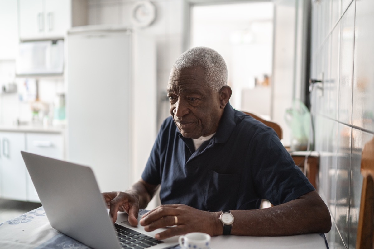 Senior man working at laptop