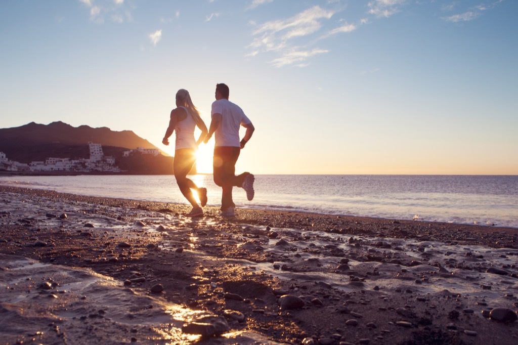 Morning run, two people on a beach